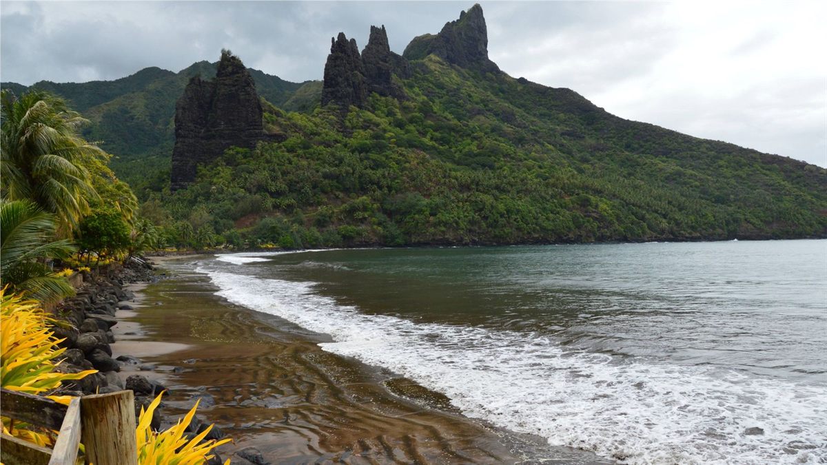 Rocky peaks and a dark-sand beach on Nuku Hiva