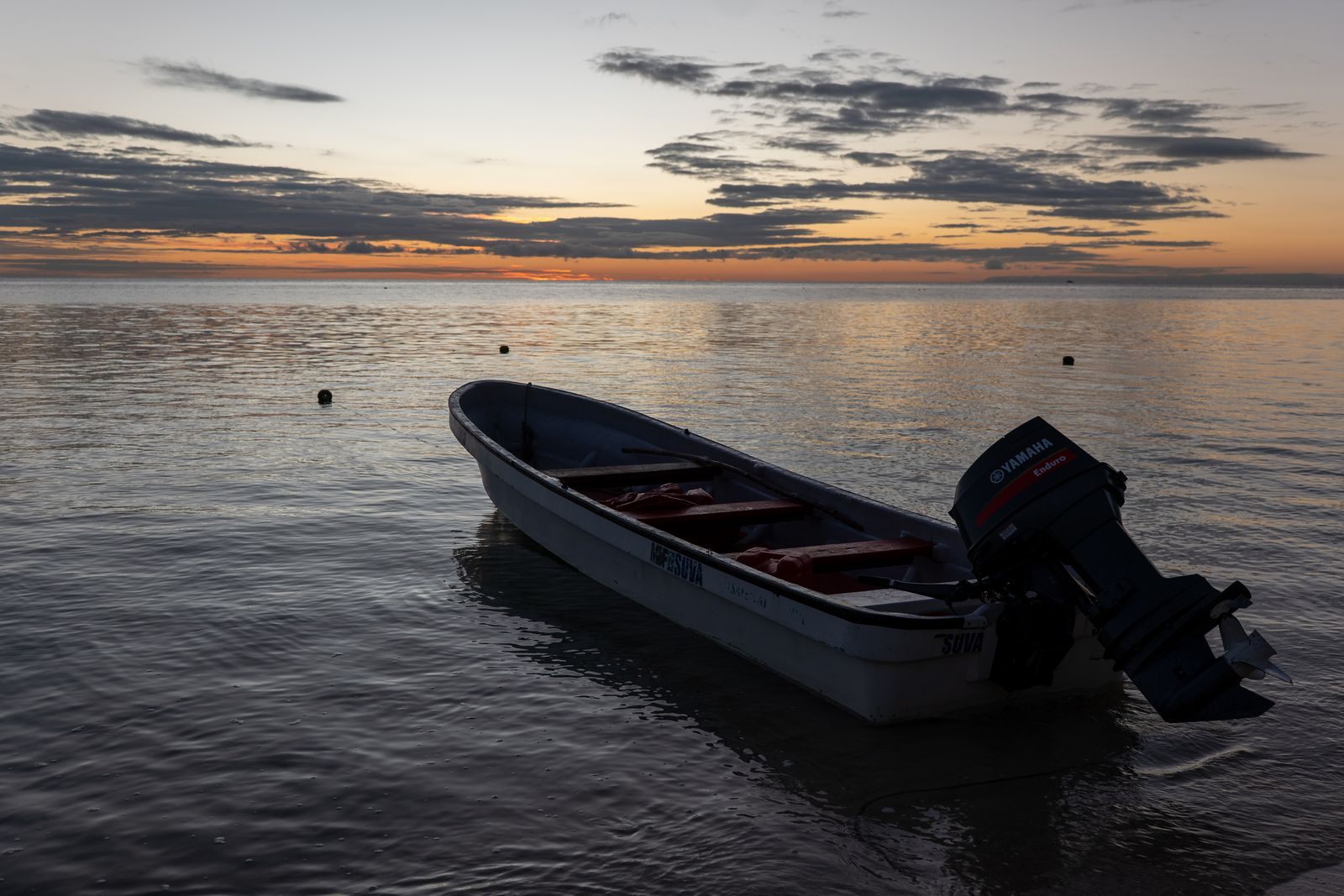 Small boat at anchor at sunrise in Fiji’s Yasawa Islands